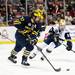 Michigan junior defenseman Mac Bennett skates up the rink with the puck in the first period of the game against Notre Dame on Sunday, March 24. Daniel Brenner I AnnArbor.com
